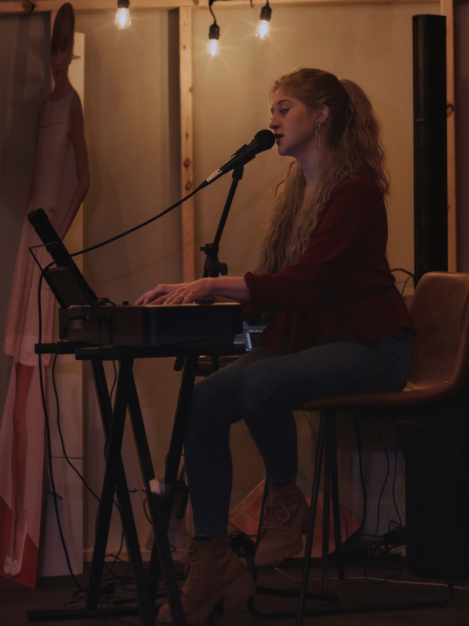 Maggie Moon performing singer-songwriter music at a keyboard
